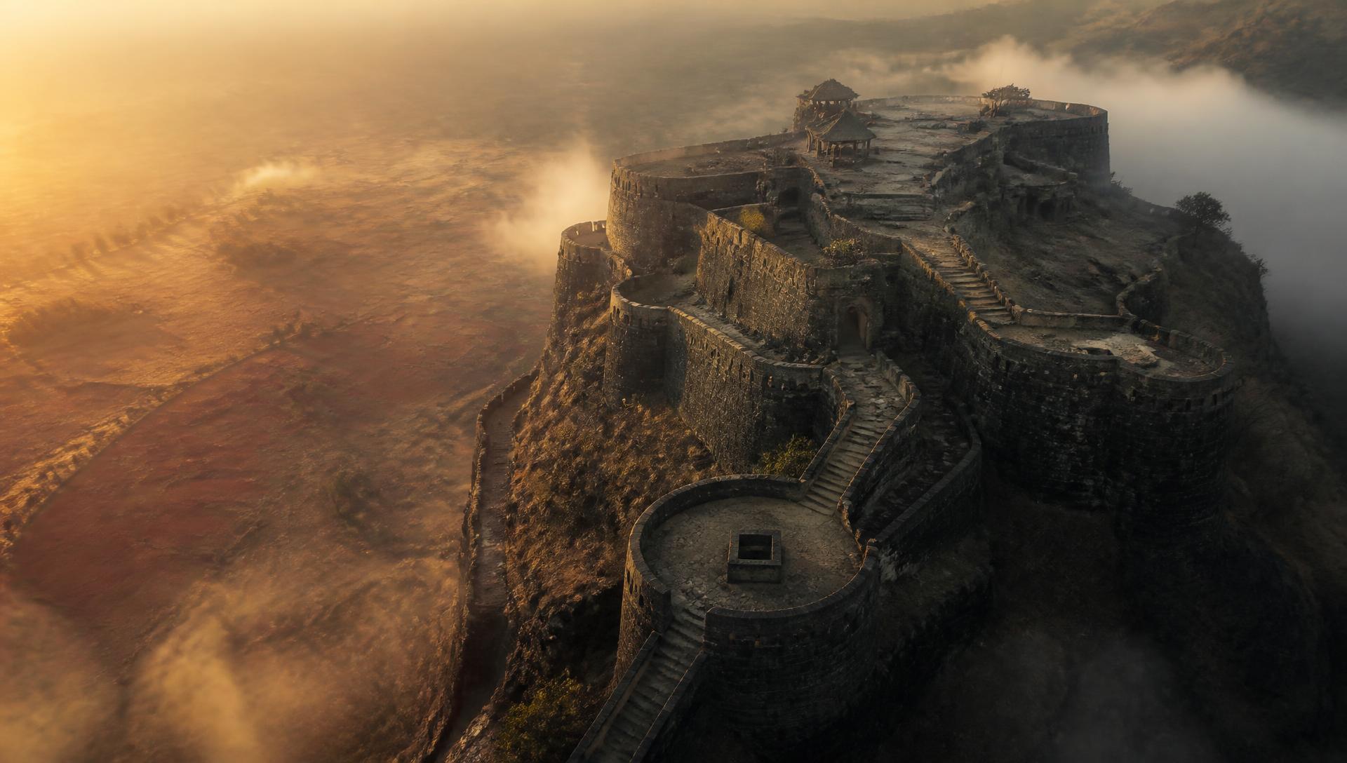 Aerial view of a Maharashtrian fort fading into chilli fields
